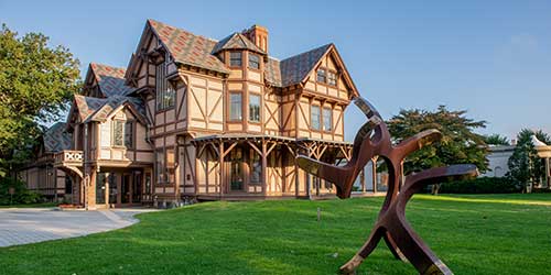 Newport Art Museum exterior featuring historic architecture, sculpture garden, and landscaped lawn.