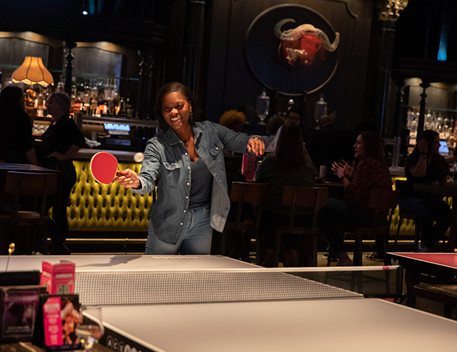 People networking and playing ping-pong during the DEAMcon23 Off-site Event at AceBounce
