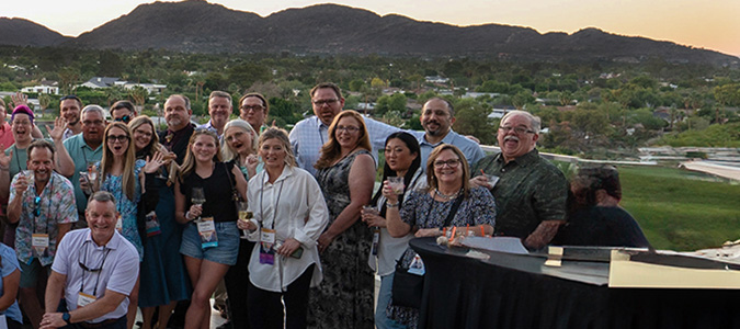 deamcon25-pano3-675x300 Large group of people with mountains in the background
